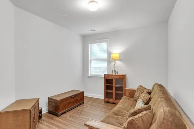 a bedroom with furniture and a lamp