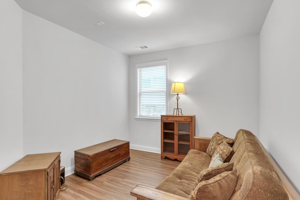 1598 Auburn Rdg Way Dacula, GA 30019 - Photo 23 of 34 a bedroom with furniture and a lamp