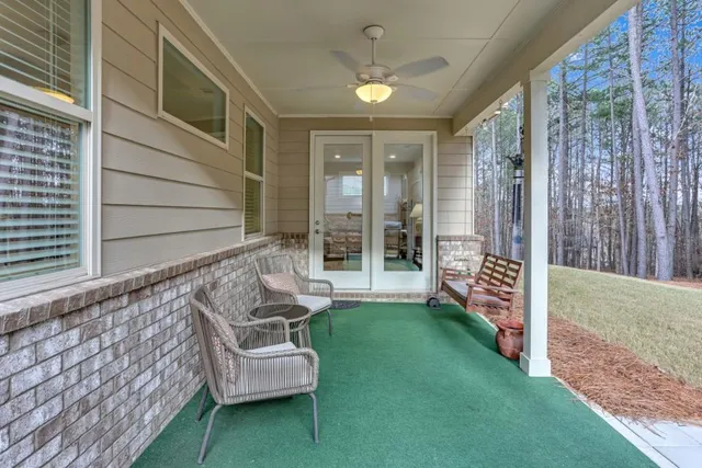 a view of a chair and fire pit in backyard of the house