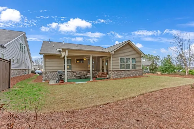 a view of a house with a yard and pathway