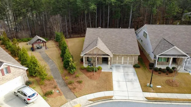 an aerial view of a house with swimming pool and porch