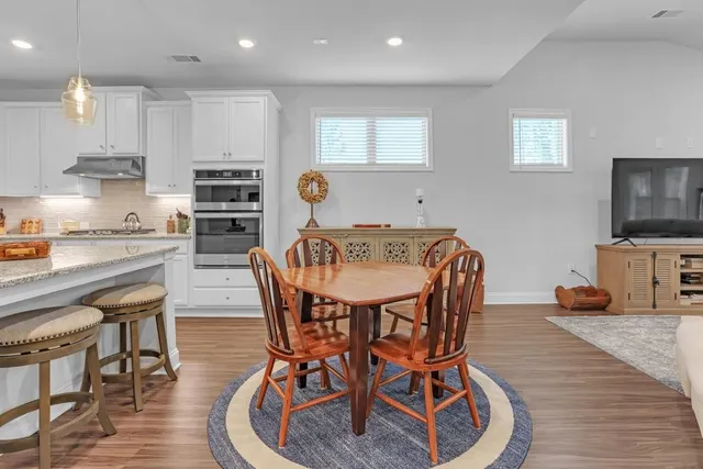a view of a dining room with furniture and wooden floor