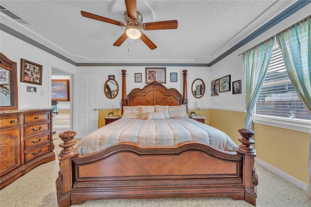 7613 Clover Lane Watauga, TX 76148 - Photo 17 of 36 Bedroom featuring a textured ceiling and a ceiling fan
