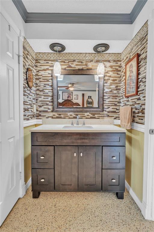 7613 Clover Lane Watauga, TX 76148 - Photo 18 of 36 Bathroom with vanity, crown molding, and dark aggregate flooring