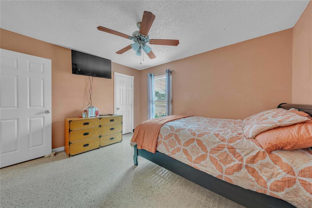7613 Clover Lane Watauga, TX 76148 - Photo 23 of 36 Bedroom with a textured ceiling and a ceiling fan