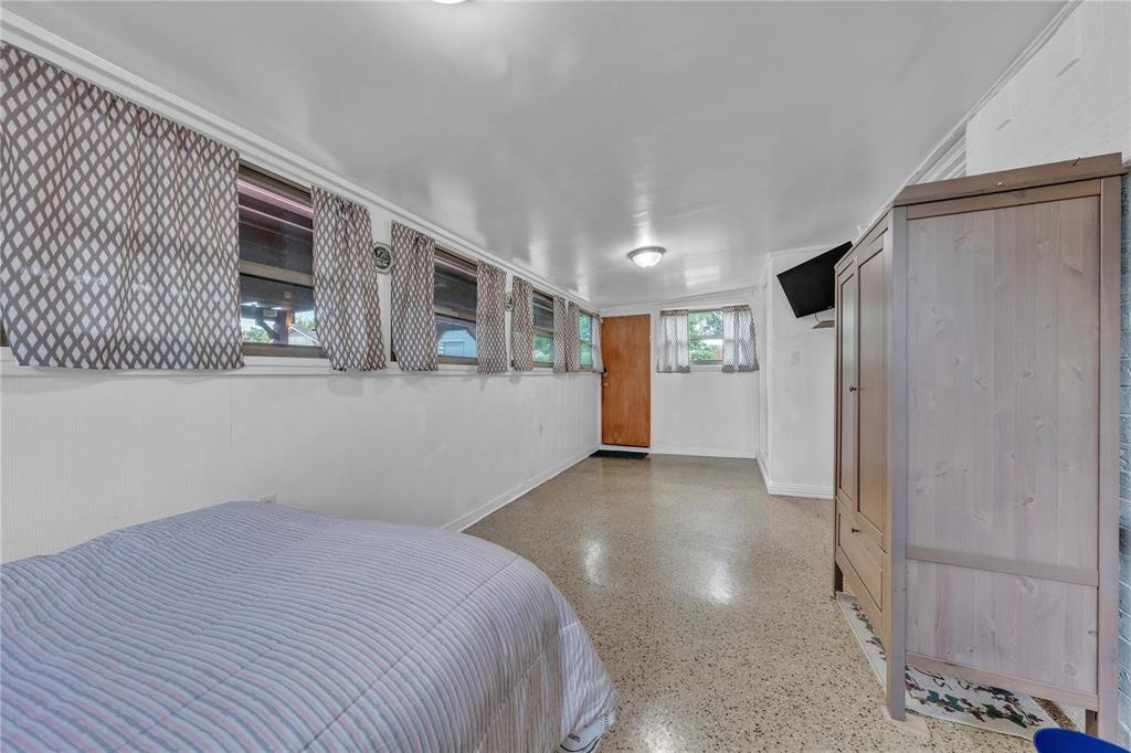 7613 Clover Lane Watauga, TX 76148 - Photo 26 of 36 Bedroom featuring baseboards and dark aggregate flooring