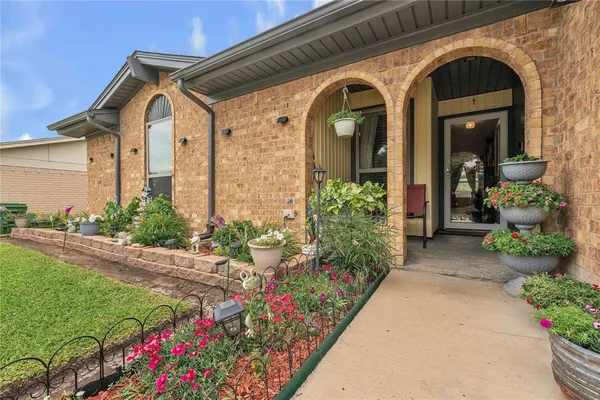 a hallway with wooden floor and windows