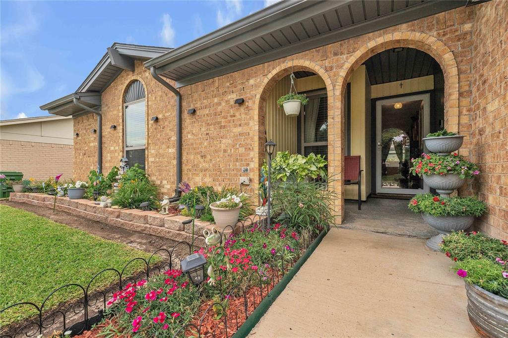 7613 Clover Lane Watauga, TX 76148 - Photo 5 of 36 Entrance to property featuring covered porch, brick siding, and a yard