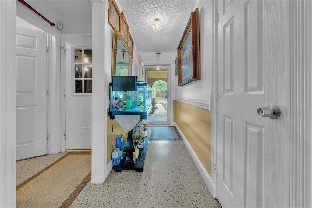 7613 Clover Lane Watauga, TX 76148 - Photo 7 of 36 Hall with a textured ceiling and dark aggregate flooring