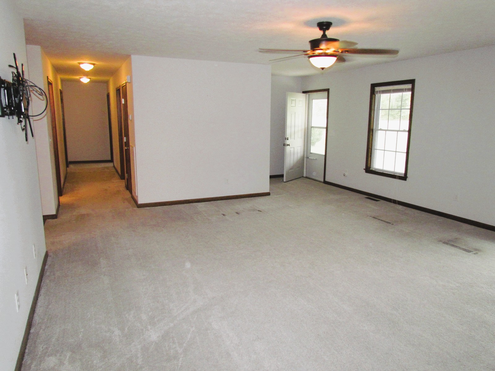 1266 Poplar Hill Road Watertown, TN 37184 - Photo 5 of 59 an empty room with windows and a chandelier fan