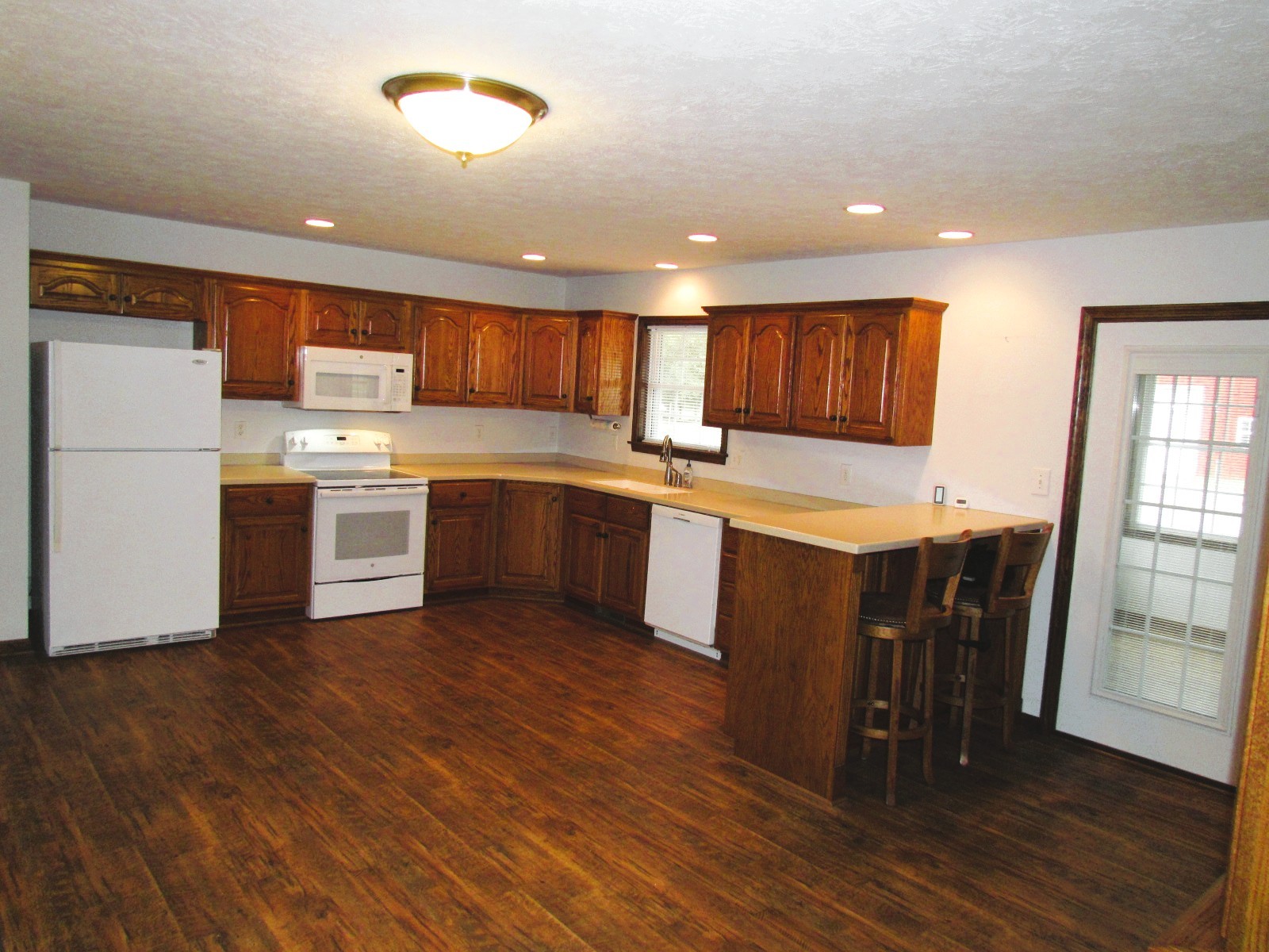 1266 Poplar Hill Road Watertown, TN 37184 - Photo 8 of 59 a kitchen with stainless steel appliances granite countertop a table chairs sink and cabinets