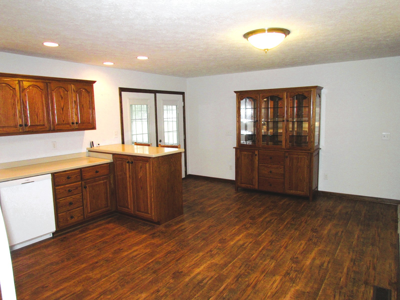 1266 Poplar Hill Road Watertown, TN 37184 - Photo 10 of 59 a kitchen with granite countertop wooden floors and wooden cabinets