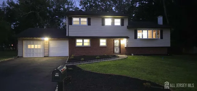 a view of an house backyard and a yard