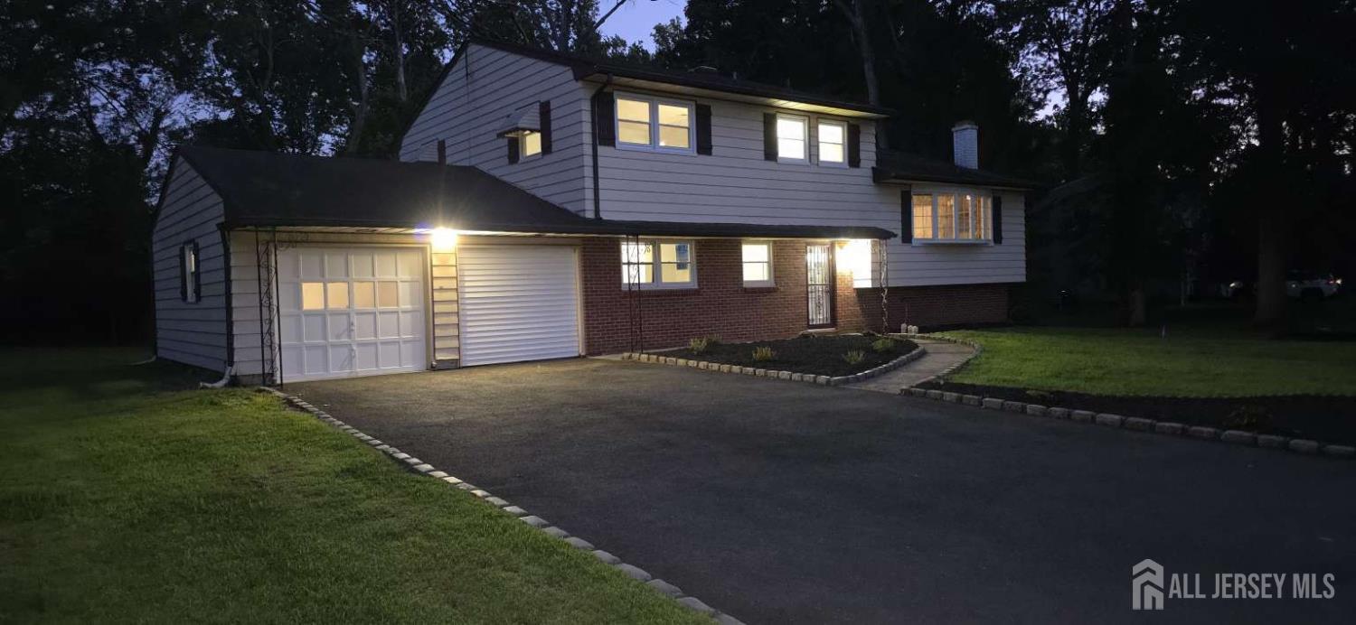 33 Nottingham Road Edison, NJ 08820 - Photo 2 of 6 a front view of a house with a yard and garage