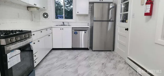 a kitchen with a refrigerator and a sink
