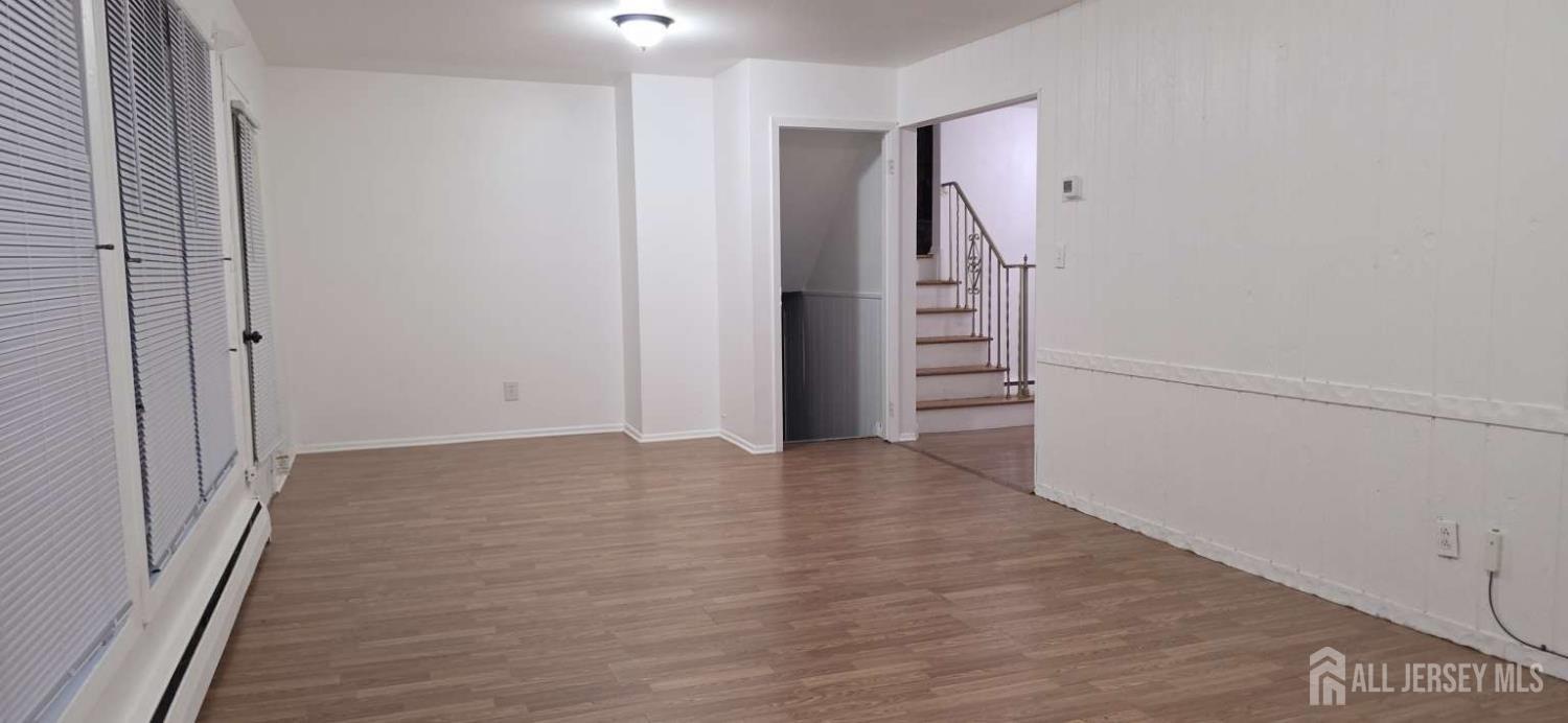 33 Nottingham Road Edison, NJ 08820 - Photo 5 of 6 a view of an empty room with stairs and ventilation