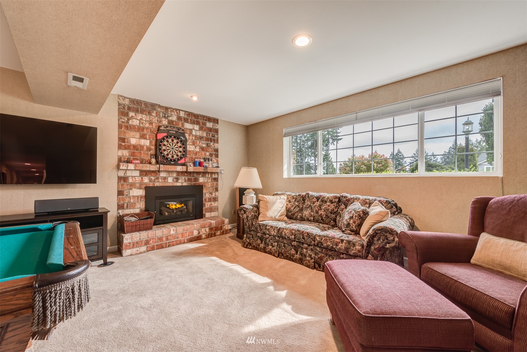 213 155th Place Southeast Bothell, WA 98012 - Photo 23 of 37 a living room with furniture a flat screen tv and a fireplace