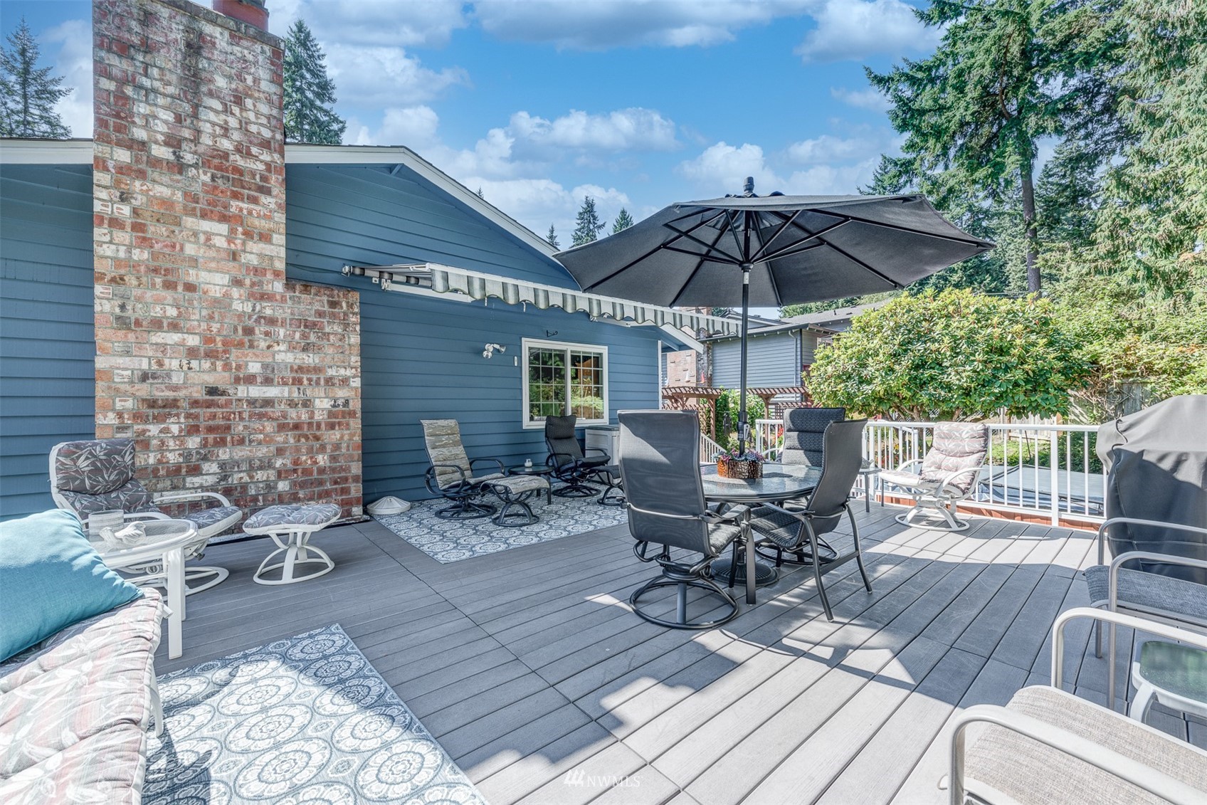 213 155th Place Southeast Bothell, WA 98012 - Photo 29 of 37 a view of patio with table and chairs under an umbrella with wooden floor