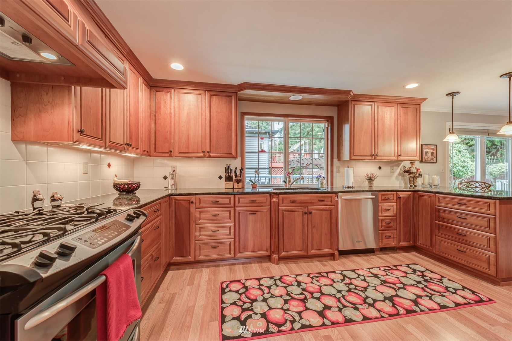 213 155th Place Southeast Bothell, WA 98012 - Photo 7 of 37 a kitchen with stainless steel appliances granite countertop a stove a sink dishwasher and a refrigerator