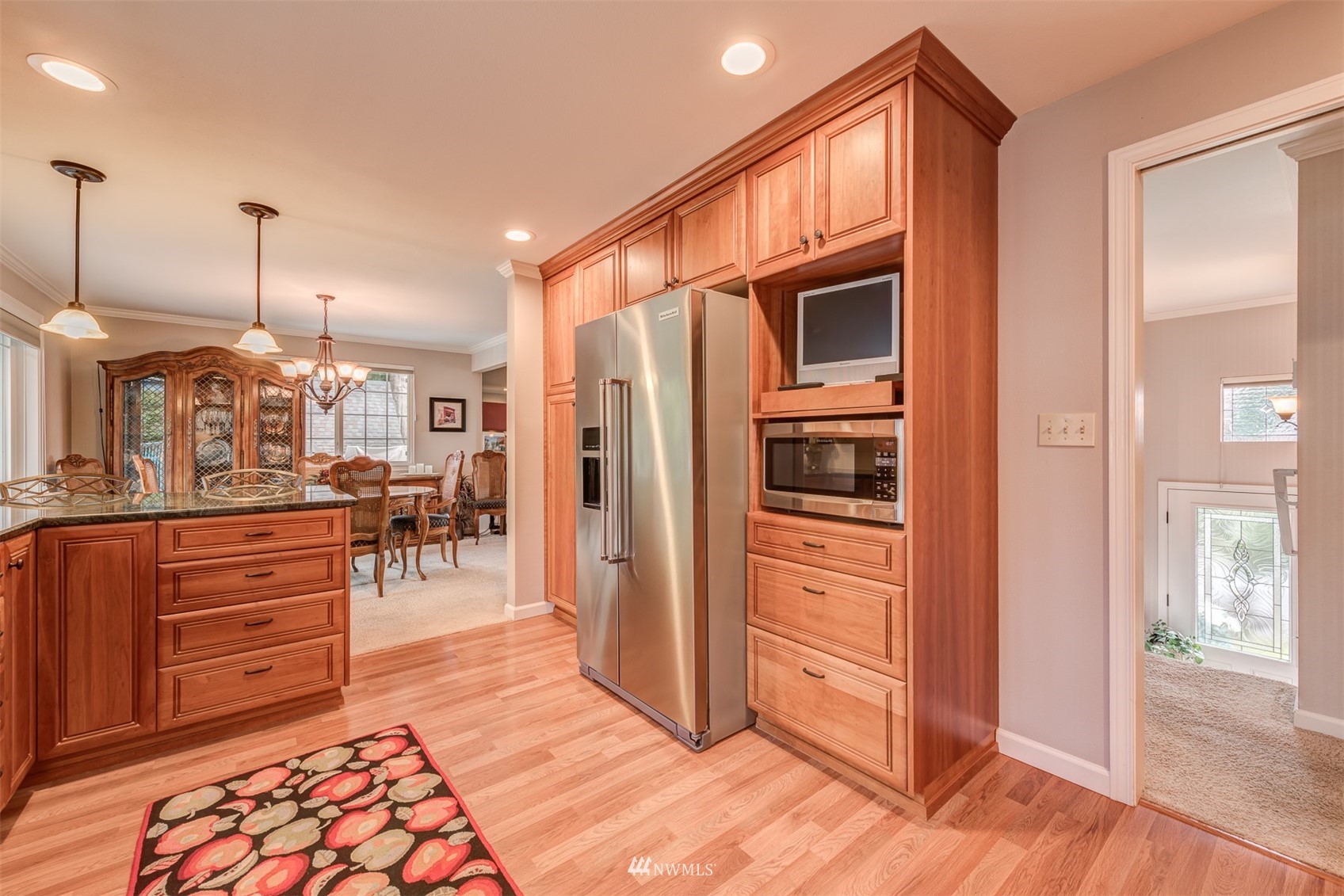 213 155th Place Southeast Bothell, WA 98012 - Photo 8 of 37 a open kitchen with stainless steel appliances granite countertop a refrigerator and wooden cabinets