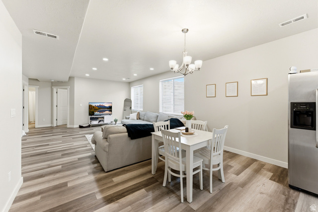1434 West Stable Street Lindon, UT 84042 - Photo 38 of 76 Dining area with light wood finished floors and a chandelier