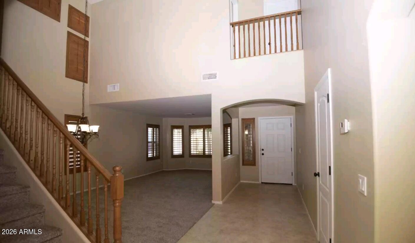 2321 West Steed Ridge Phoenix, AZ 85085 - Photo 2 of 14 a view of a hallway with wooden floor and staircase