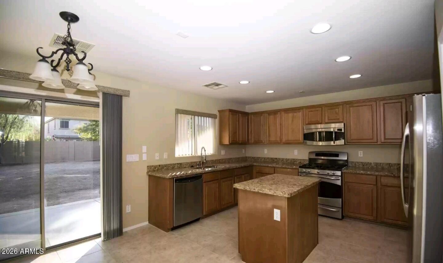 2321 West Steed Ridge Phoenix, AZ 85085 - Photo 4 of 14 a kitchen with a sink a stove and refrigerator