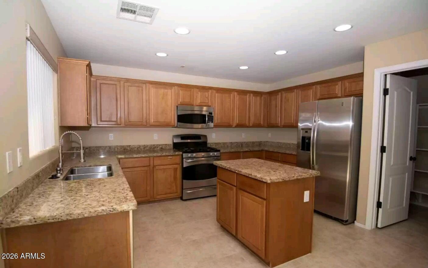 2321 West Steed Ridge Phoenix, AZ 85085 - Photo 5 of 14 a kitchen with stainless steel appliances granite countertop a sink stove and refrigerator
