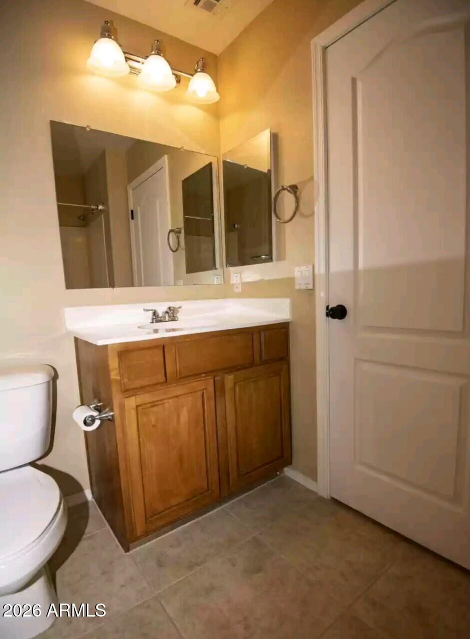 2321 West Steed Ridge Phoenix, AZ 85085 - Photo 7 of 14 a bathroom with a sink mirror vanity and toilet