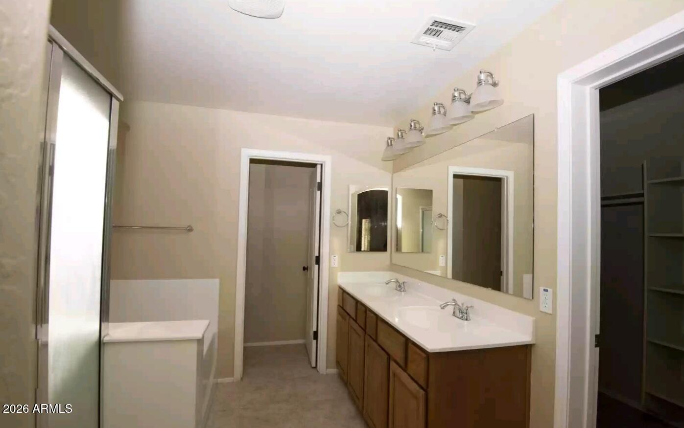 2321 West Steed Ridge Phoenix, AZ 85085 - Photo 8 of 14 a bathroom with a sink a mirror and a shower