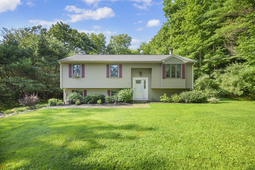 73 Hill Road Charlton, MA 01507 - Photo 1 of 32 a front view of a house with a yard and trees
