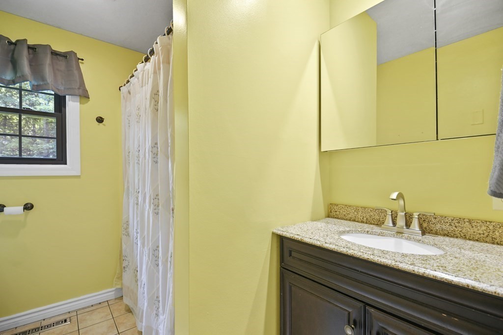 73 Hill Road Charlton, MA 01507 - Photo 13 of 32 a bathroom with a granite countertop sink and a mirror