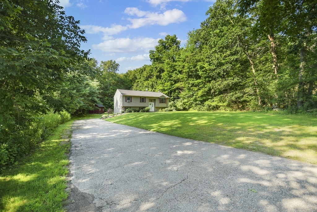 73 Hill Road Charlton, MA 01507 - Photo 26 of 32 a view of a house with backyard and trees