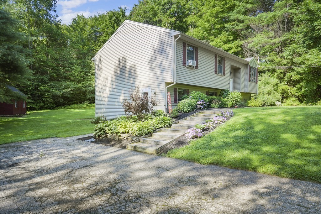 73 Hill Road Charlton, MA 01507 - Photo 27 of 32 a front view of a house with a yard