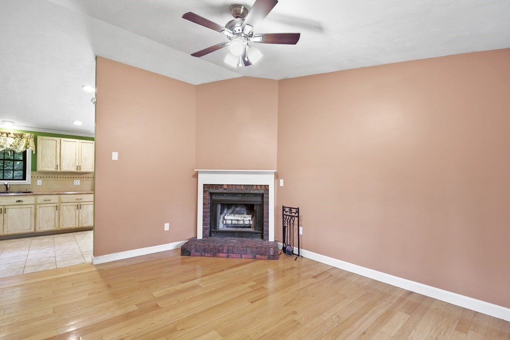 73 Hill Road Charlton, MA 01507 - Photo 3 of 32 a view of empty room with kitchen and fireplace