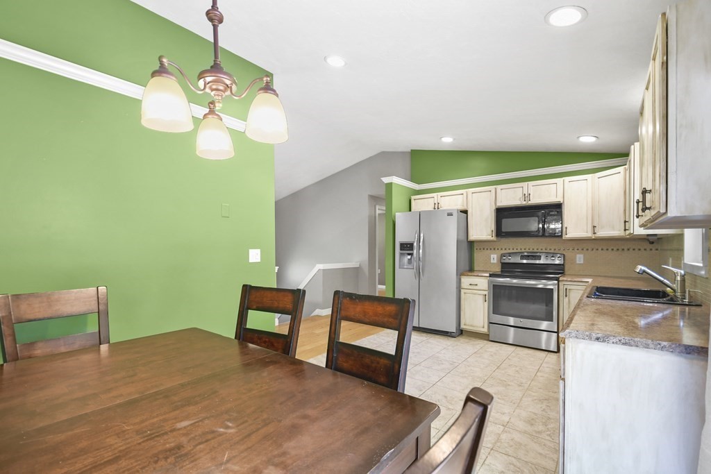 73 Hill Road Charlton, MA 01507 - Photo 6 of 32 a living room with furniture two large window and a fireplace