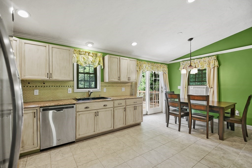 73 Hill Road Charlton, MA 01507 - Photo 7 of 32 a large kitchen with kitchen island granite countertop a table and chairs