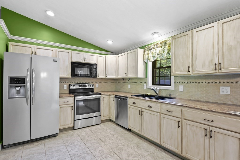 73 Hill Road Charlton, MA 01507 - Photo 8 of 32 a kitchen with granite countertop white cabinets and stainless steel appliances