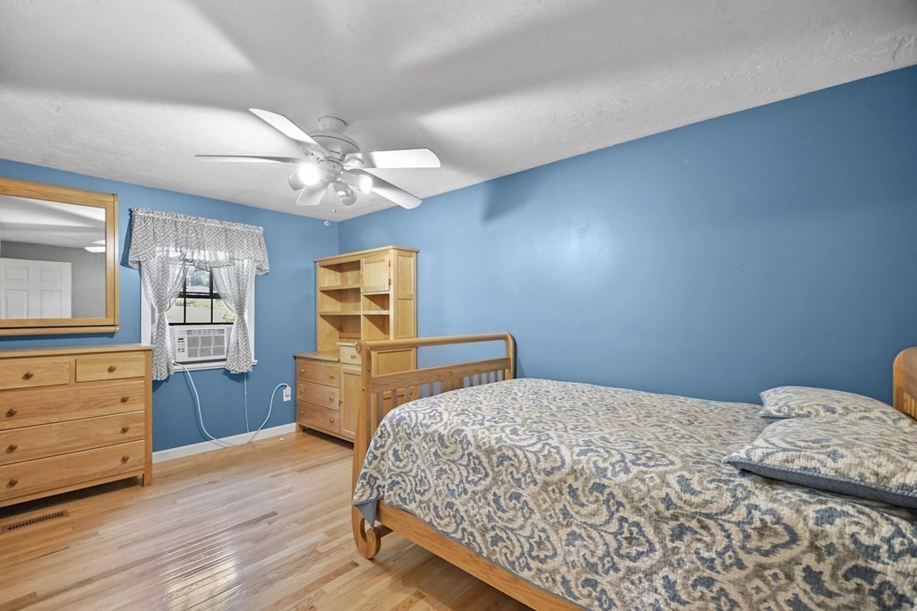 73 Hill Road Charlton, MA 01507 - Photo 10 of 32 a bedroom with a bed and wooden floor