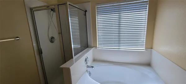 a bathroom with a shower and a tub