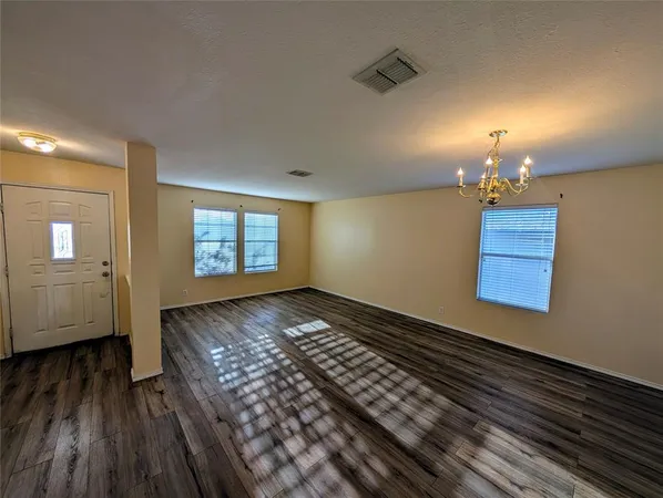a kitchen with stainless steel appliances granite countertop a sink a stove and wooden floor
