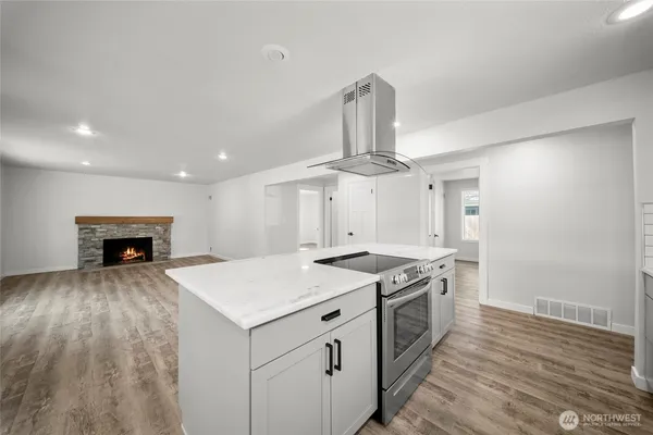 a kitchen with a stove a sink and a refrigerator