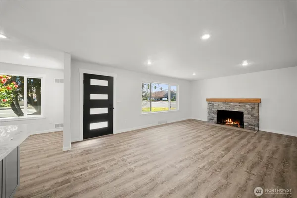 a view of a livingroom with a fireplace and window