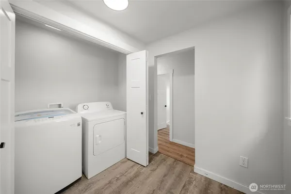 a view of a storage & utility room with a washer dryer