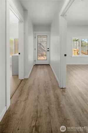an empty room with windows and closet