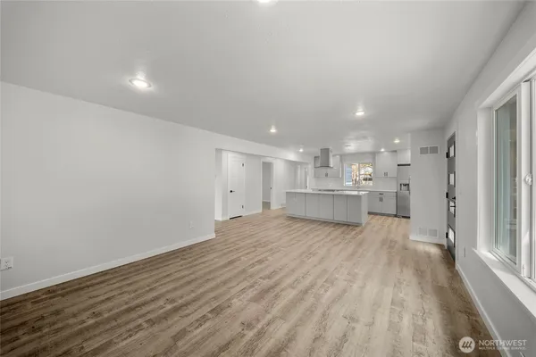 a view of a kitchen with a sink and wooden floor