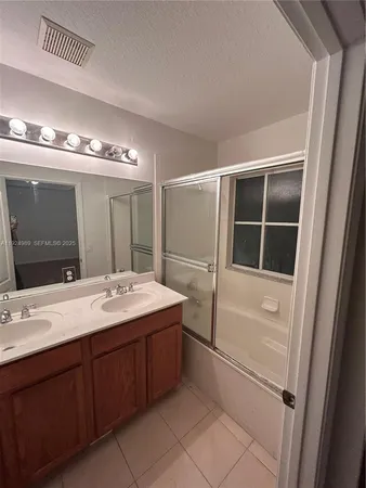 a bathroom with a sink and mirror
