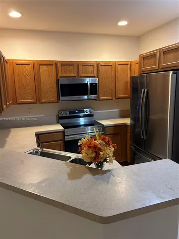 a kitchen with a refrigerator and a sink