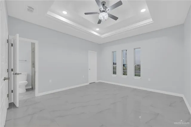 a bathroom with a granite countertop sink a toilet and a mirror