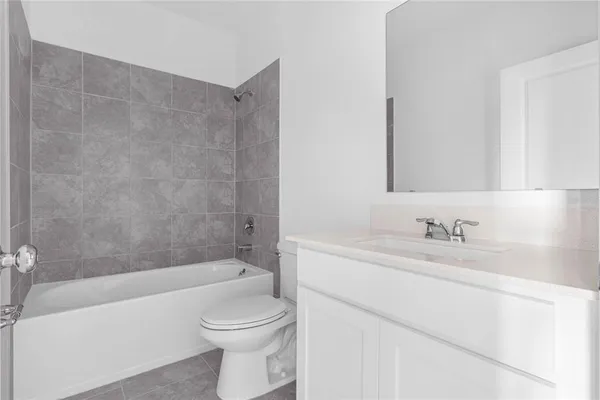 a bathroom with a toilet a bath tub a sink and mirror